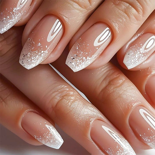 Nails with a gradient design and glittery finish on a neutral background