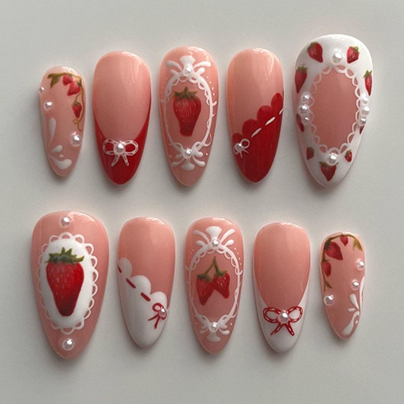 Sweet Strawberry Bliss Medium Almond Pink Nail Set with Decorative Pearls and Intricate Designs