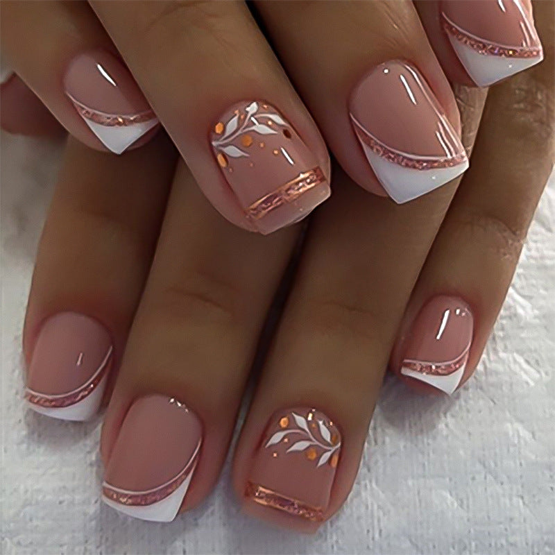 Nails with a pink and white design on a textured surface