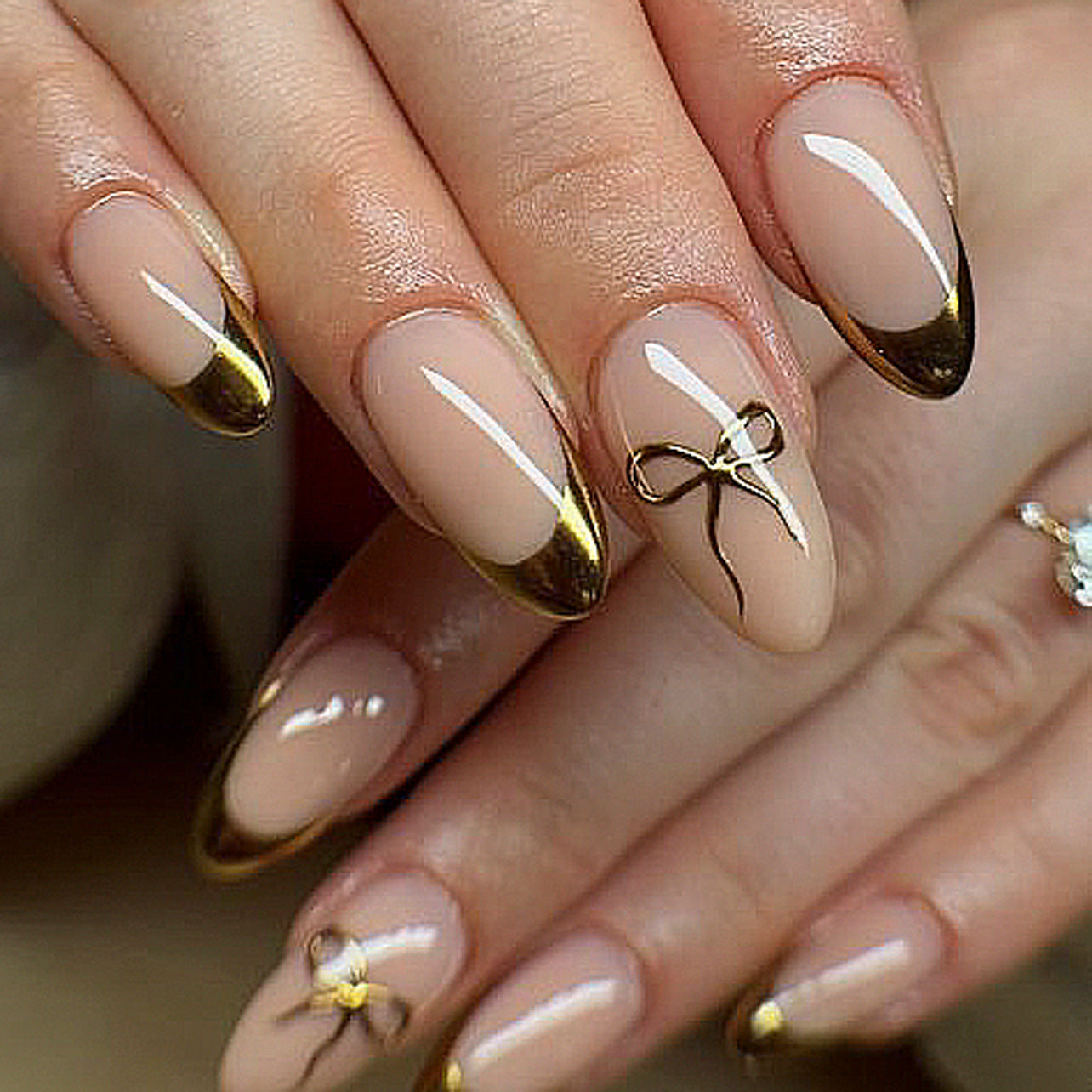 Elegant Charm Medium Almond Shaped Beige and Gold Press On Nail Set with Delicate Bow Accents