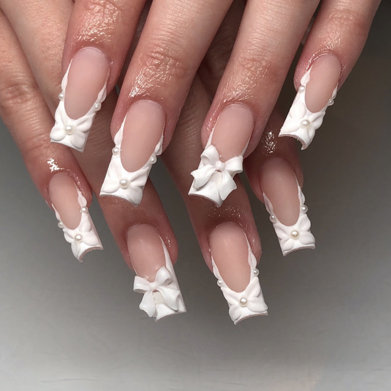 Whimsical Elegance Long Square White Nails with Charming Bow and Pearl Accents