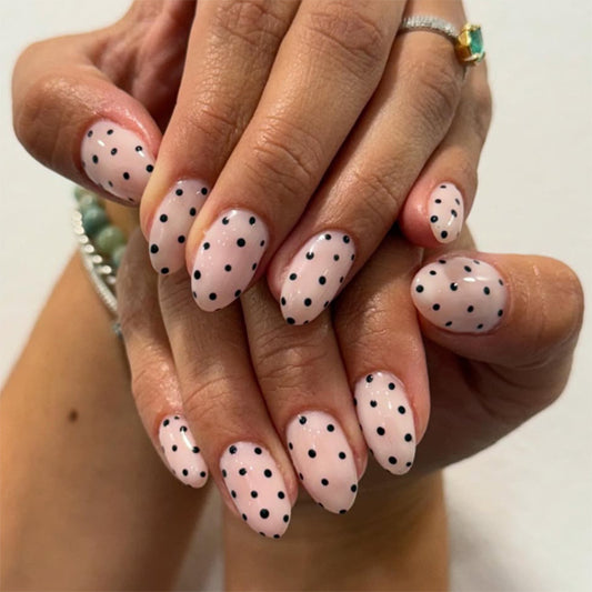 Elegant Whimsy Press on Nail Set in Medium Length Oval Shape Soft Pink with Chic Black Polka Dots