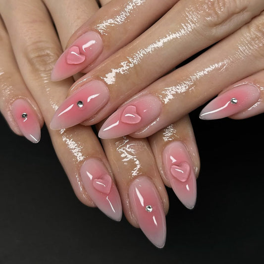Romantic Elegance Long Almond Pink Nails with Heart Details and Shimmering Accents
