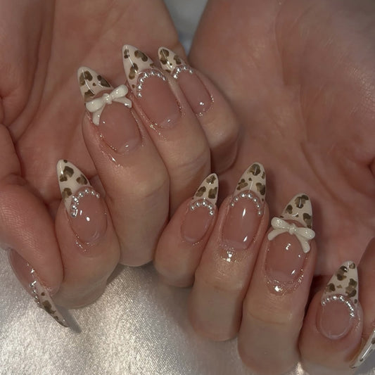 Glamorous Safari Inspired Press on Nail Set with Long Almond Shape in Beige and Brown Leopard Print Featuring Charming Bow Details and Pearl Accents