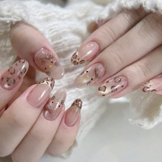 Charming Feline Inspired Long Oval Shaped Soft Beige Nails with Adorable Leopard Print Design