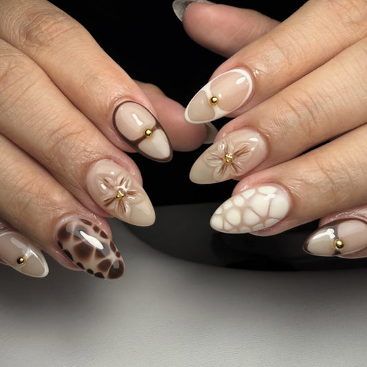 Bohemian Chic Medium Almond Beige Nails with Floral Accents and Gold Studs