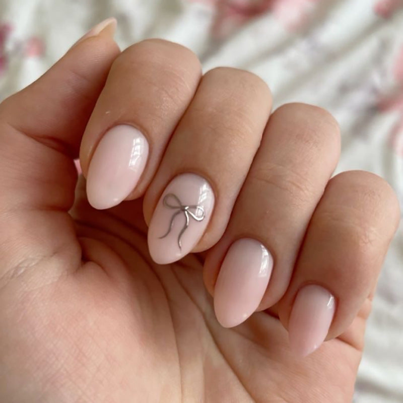 Charming Elegance Medium Almond Pink Nails with Dainty Bow Accent