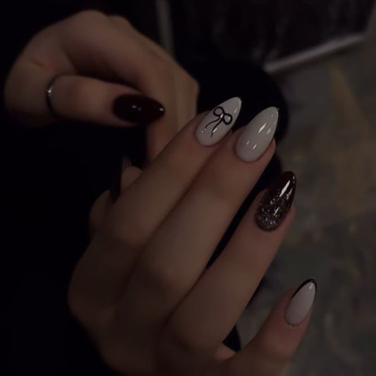 Glamorous Night Inspired Medium Almond Shaped Burgundy and Beige Press on Nail Set with Elegant Bow Design and Sparkling Accent