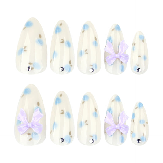 Charming Blossom Inspired Press On Nail Set Long Almond Shape Soft White with Blue Floral Design and Adorable Bow Accents