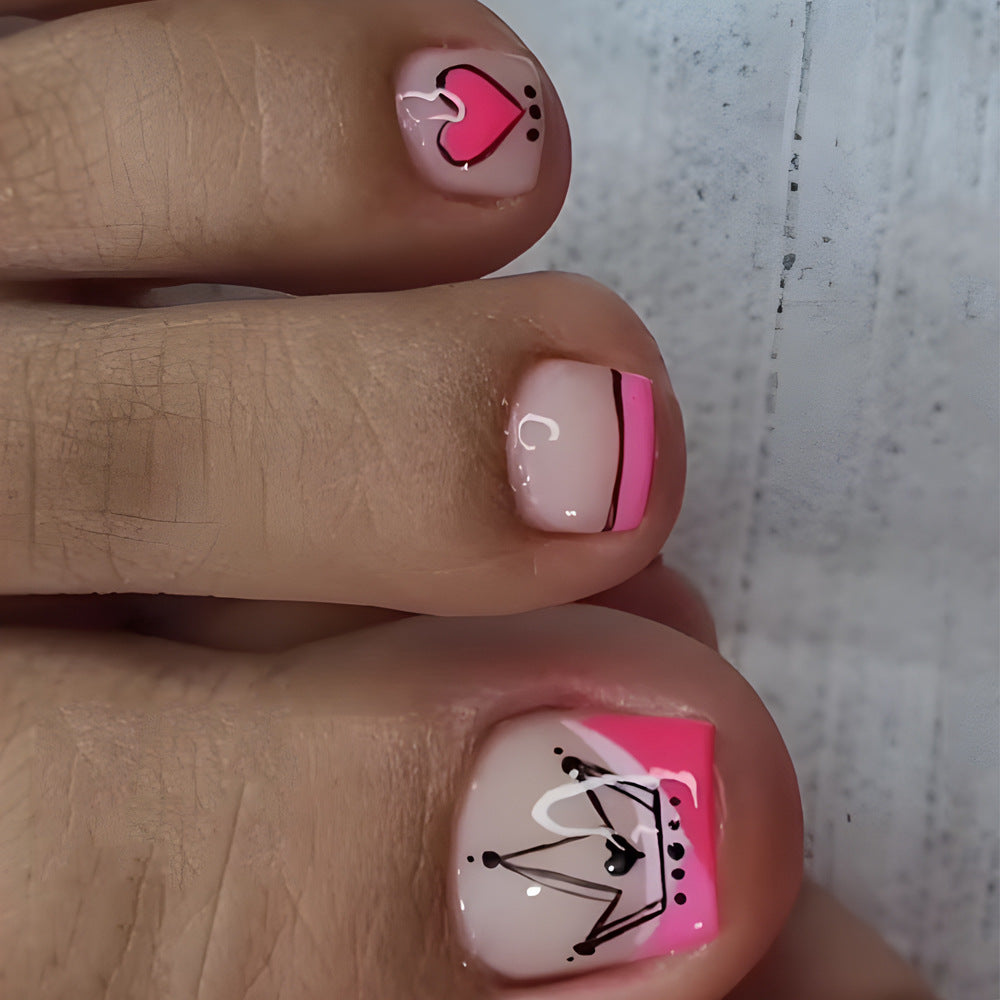 A set of press-on nails featuring short square shapes in pink and white with accent flamingo designs.