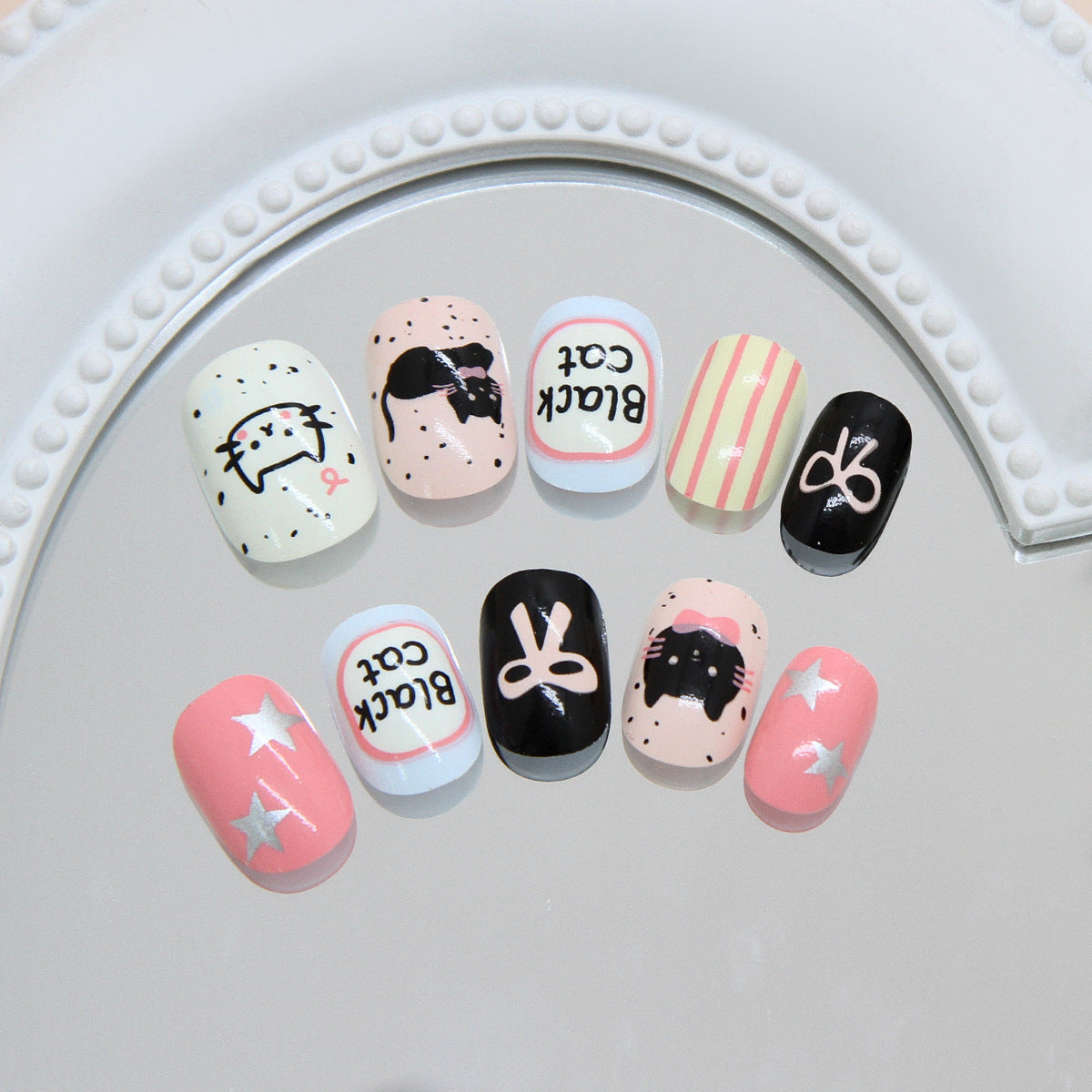 Whimsical Cat Theme Short Oval Pastel and Black Nail Set with Fun Illustrations