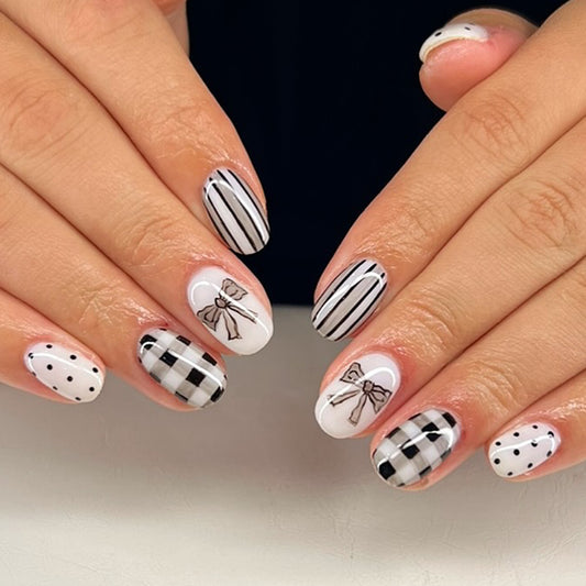 Chic Bowtie Elegance Medium Oval Black and White Press On Nail Set with Unique Patterned Designs