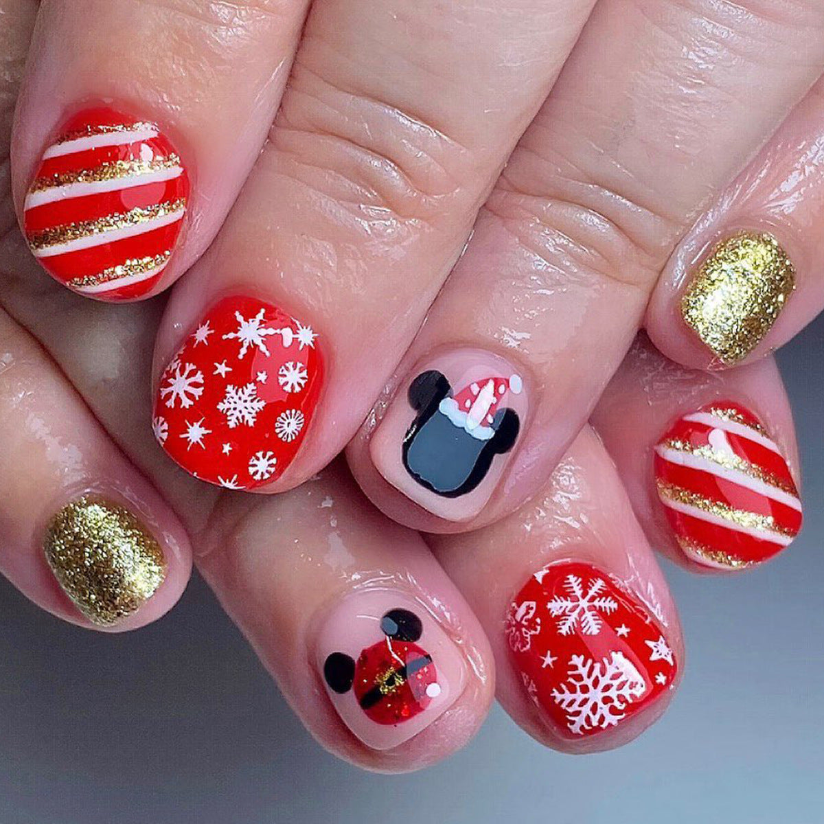 Festive Holiday Short Round Red Press On Nail Set With Glitter Gold And Whimsical Mickey Mouse Designs