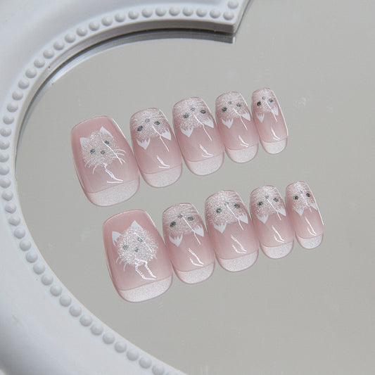 Set of pink nail art with white designs on a gray surface