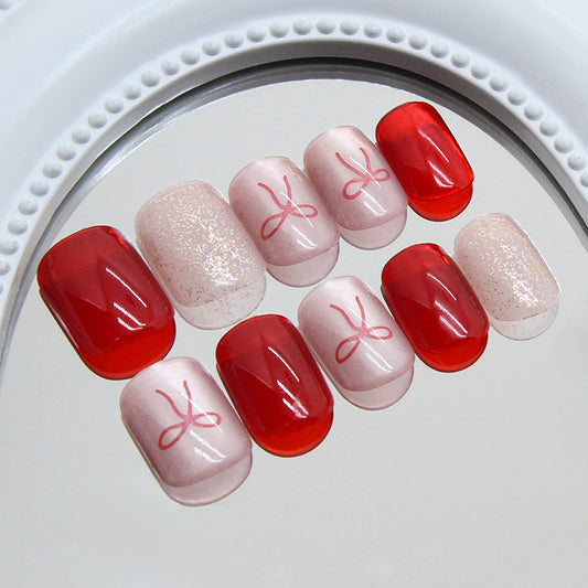 Enchanting Elegance Short Squoval Red and Pink Nail Set with a Charming Bow Design