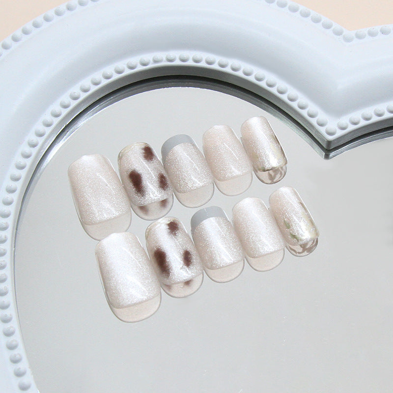 Enchanting Elegance Short Squoval Creamy White Press-On Nail Set with Stunning Glossy Finish and Unique Spot Design