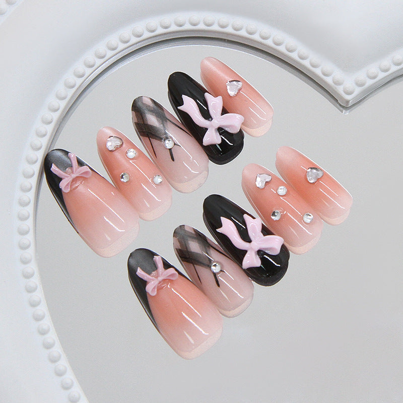 Chic Elegance Long Oval Pink and Black Press on Nail Set with Charming Bow Accents and Sparkling Gems