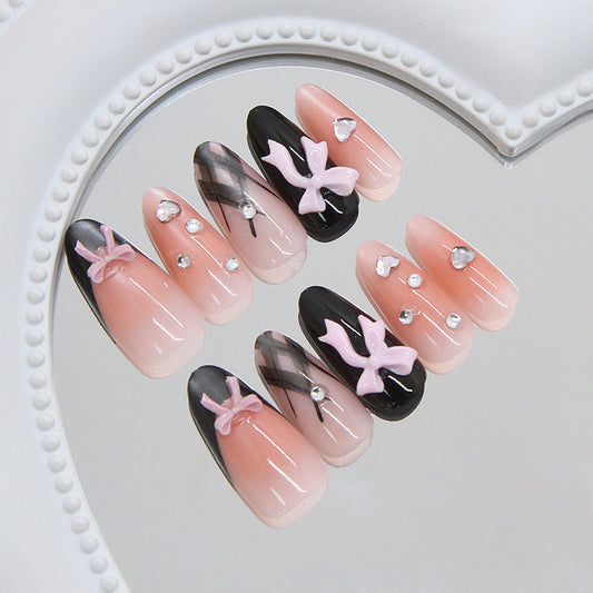 Chic Elegance Long Oval Pink and Black Press on Nail Set with Charming Bow Accents and Sparkling Gems