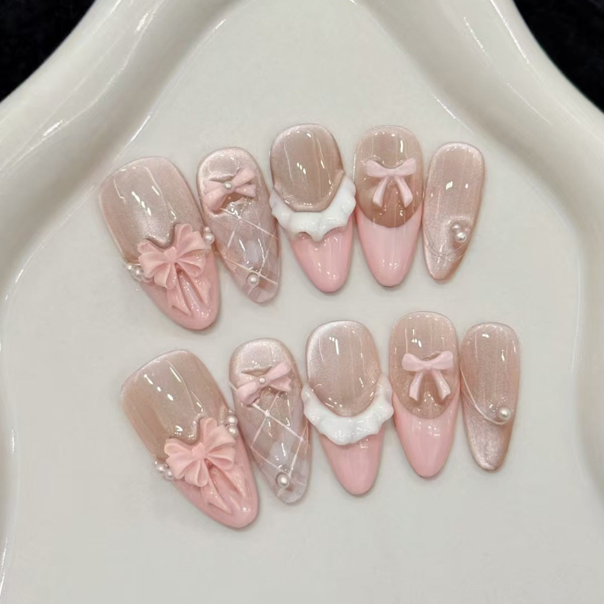 Chic Ballet Inspired Long Almond Pink Nail Set with Elegant Bow Detailing and Pearlescent Shine