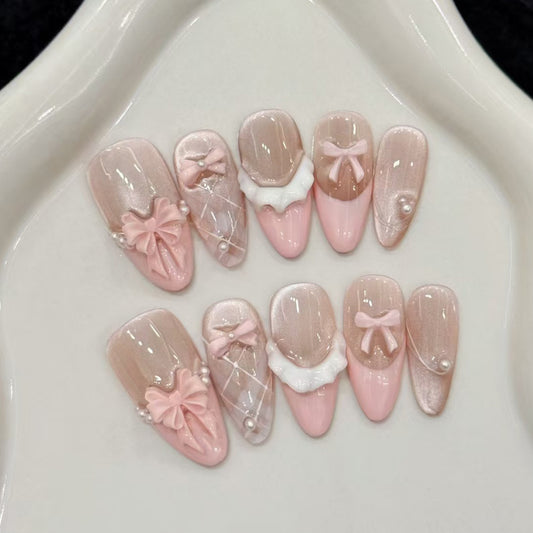 Chic Ballet Inspired Long Almond Pink Nail Set with Elegant Bow Detailing and Pearlescent Shine