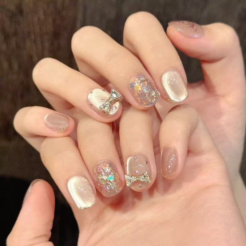 Whimsical Charm Short Squoval Blush Pink Nail Set with Sparkling Glitter and Bow Accents