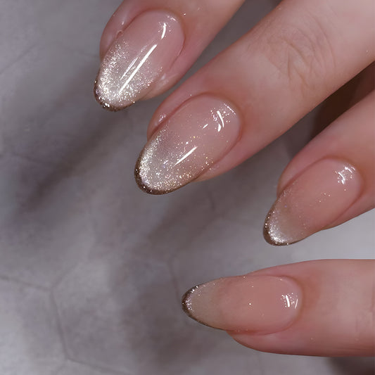 Close-up of a hand with glittery nail polish on a neutral background