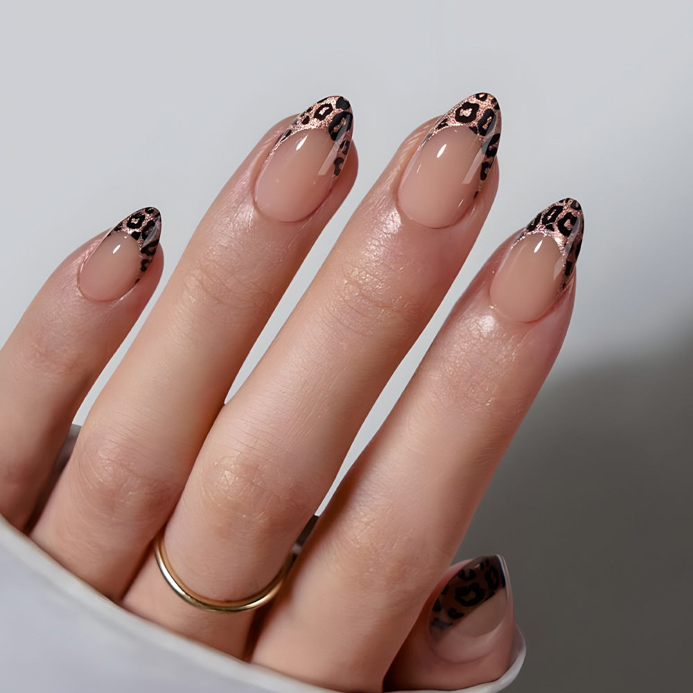 Nail art with leopard print design on a neutral background