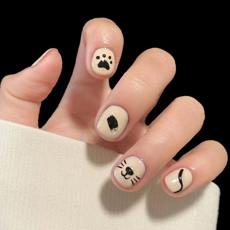 Whimsical Animal Faces Short Oval Beige Press On Nail Set with Black Accents and Unique Character Designs