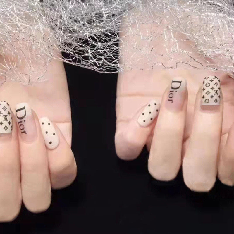 Designer Chic Extra Medium Round Beige Press On Nail Set With Brand Inspired Patterns