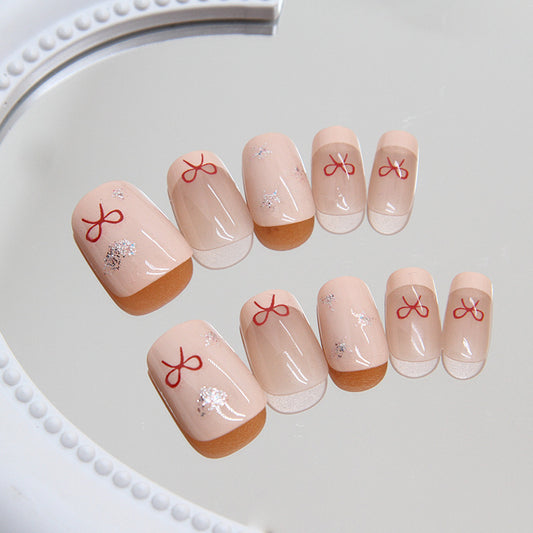 Cherry Blossom Festival Short Round Beige Press On Nail Set with Red Bow Accents and Sparkle Highlights