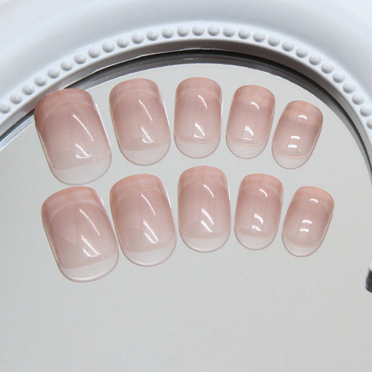 A set of extra short squoval pink glossy press-on nails displayed on a white surface.