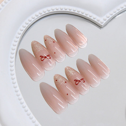 Chic Elegance Long Almond Shaped Soft Pink Nails with Unique Bow Accents