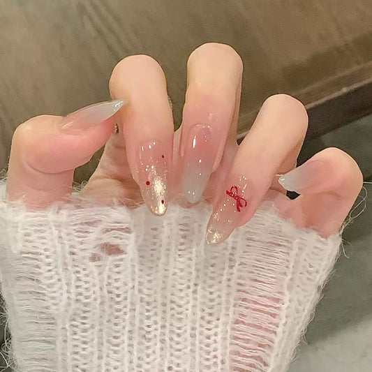 Close-up of a hand with decorative nails wearing a textured white sleeve.