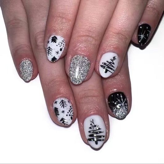 Winter Wonderland Short Oval Shaped Press On Nail Set in Elegant Black and White with Glittery Snowflake Designs