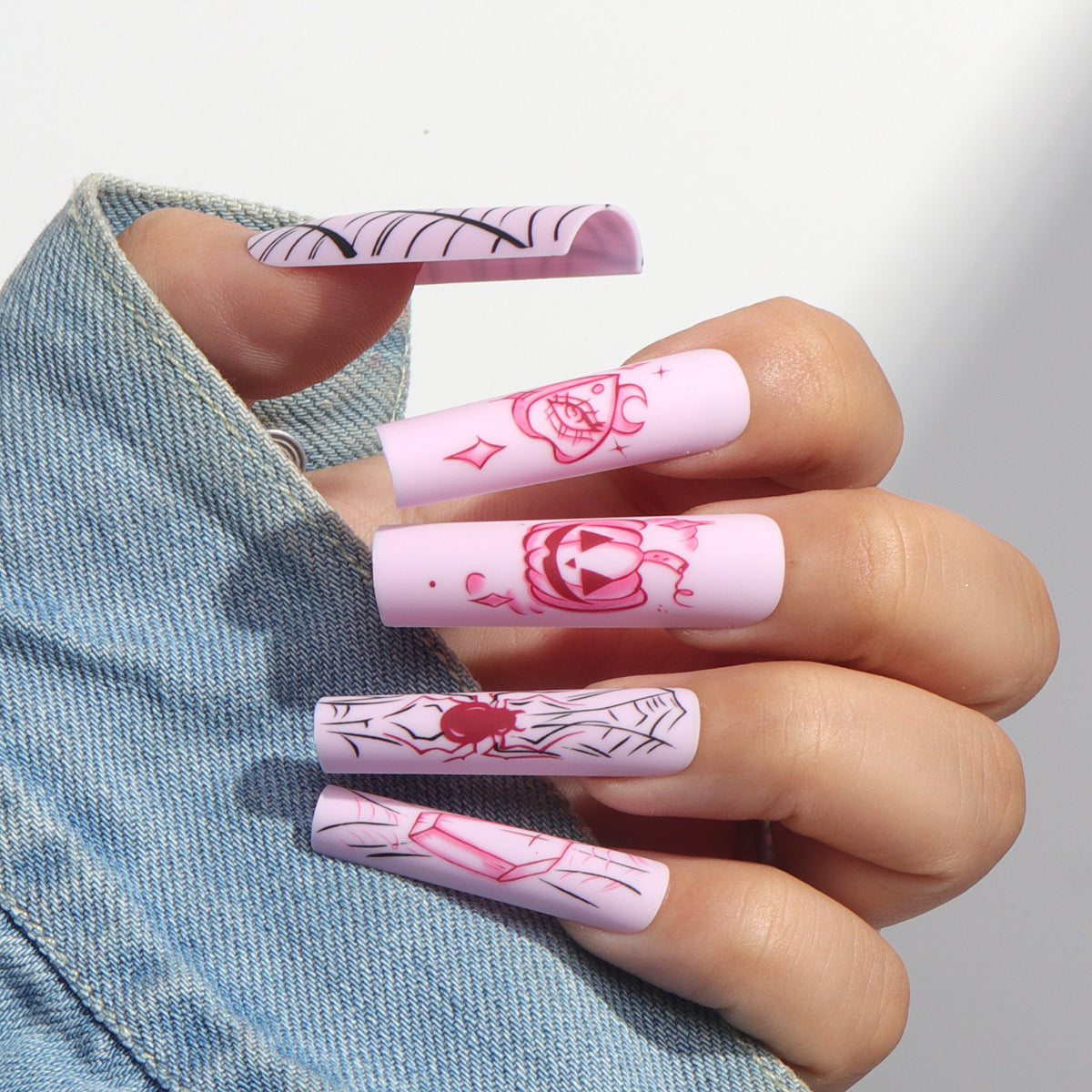 Spooky Chic Long Square Pink Nails with Unique Spooky Graphics and Matte Finish