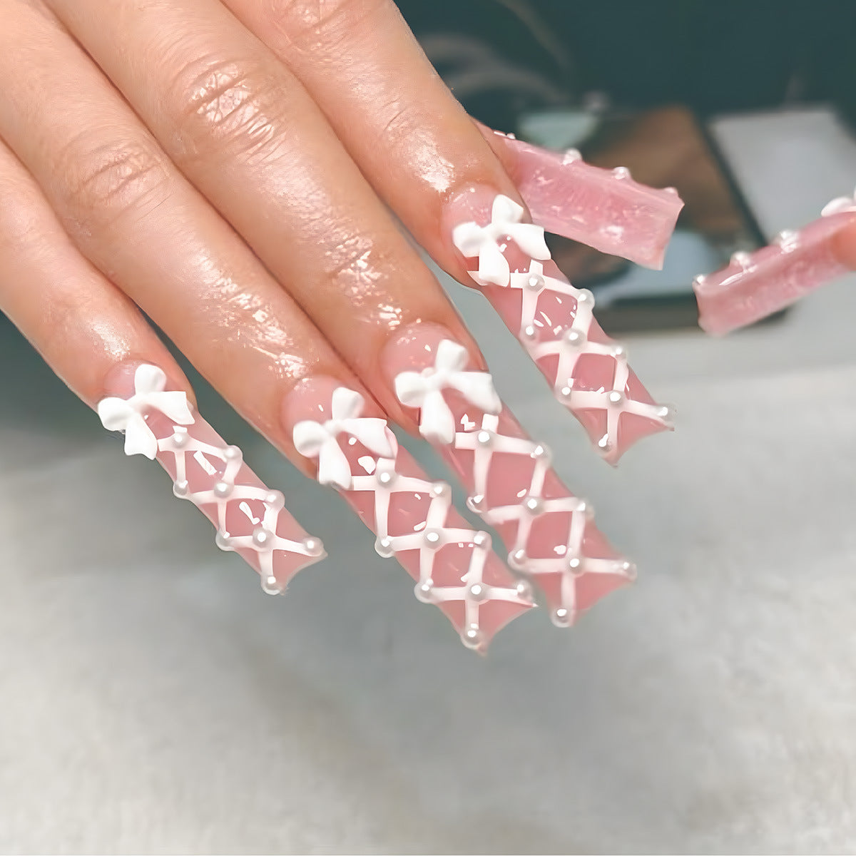 Chic Elegance Long Square Pink Nail Set with Intricate Bow and Pearl Design