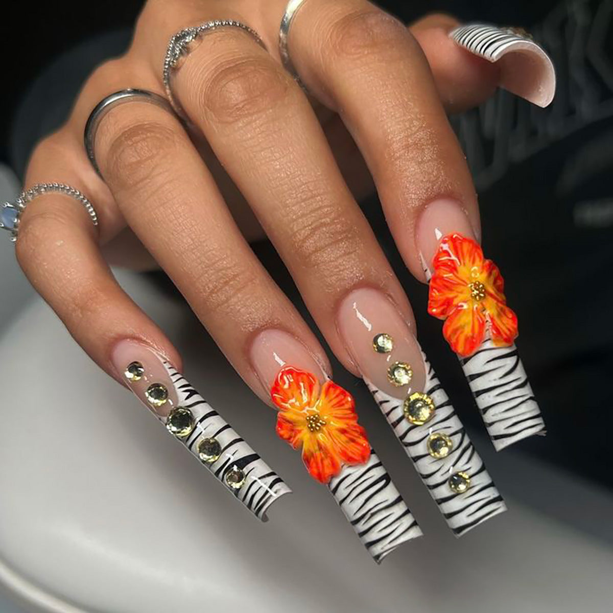 Tropical Vibes Long Square Press On Nail Set in Black and White Zebra Pattern with Vibrant Floral Accents and Rhinestone Embellishments