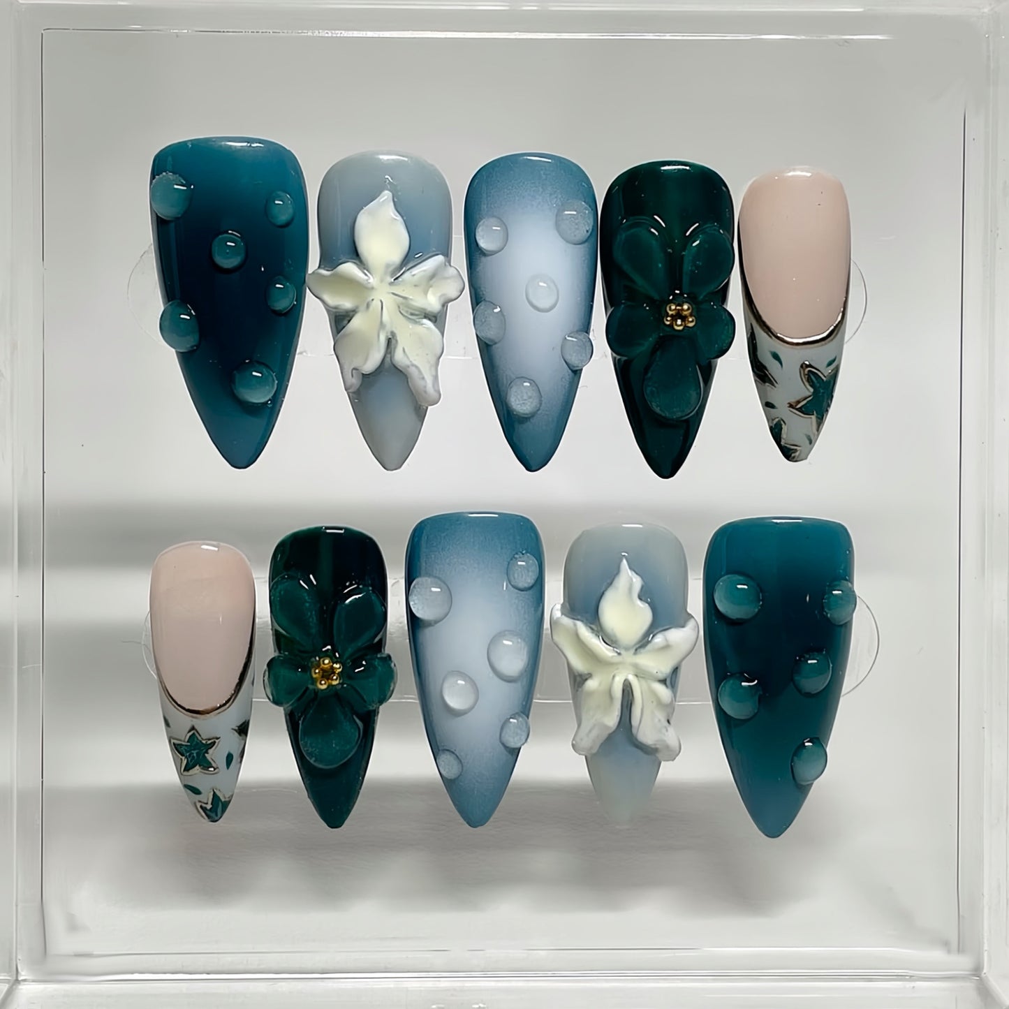 Oceanic Serenity Elegant Long Almond Shaped Teal and Light Blue Press-On Nail Set with Artistic Floral Designs and Textured Accents