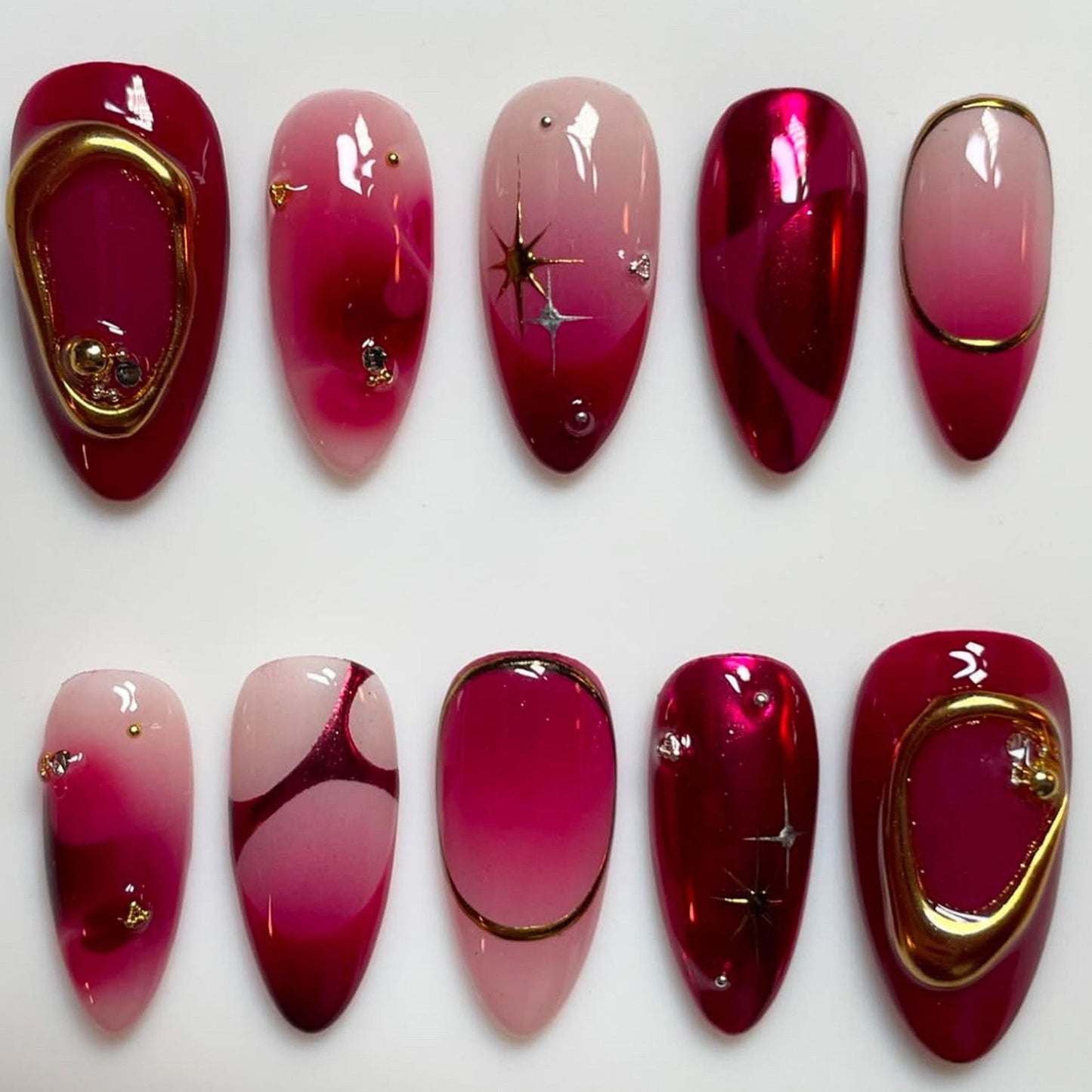 Glamorous Radiance Long Almond Shaped Deep Crimson Nails with Dazzling Gold Accents