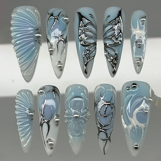 Whimsical Serenity Long Stiletto Blue Nails with Silver Embellishments and Artful Designs