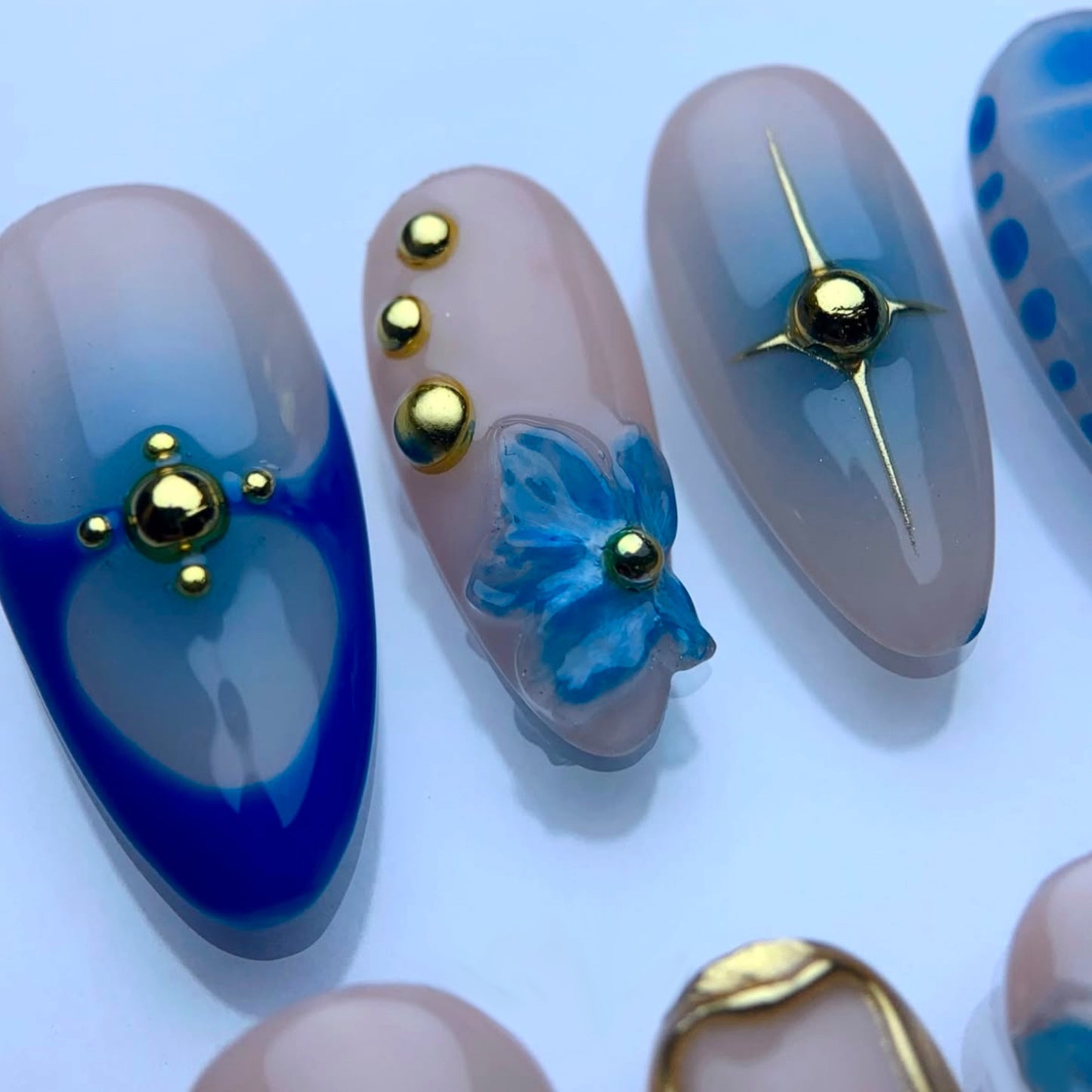 Enchanting Ocean Breeze Long Almond Shaped Blue and Beige Press on Nail Set with Unique Floral and Metallic Accents