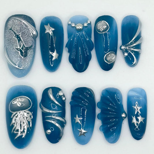 Oceanic Elegance Long Almond Blue Glossy Press On Nail Set Featuring Unique Metallic Designs