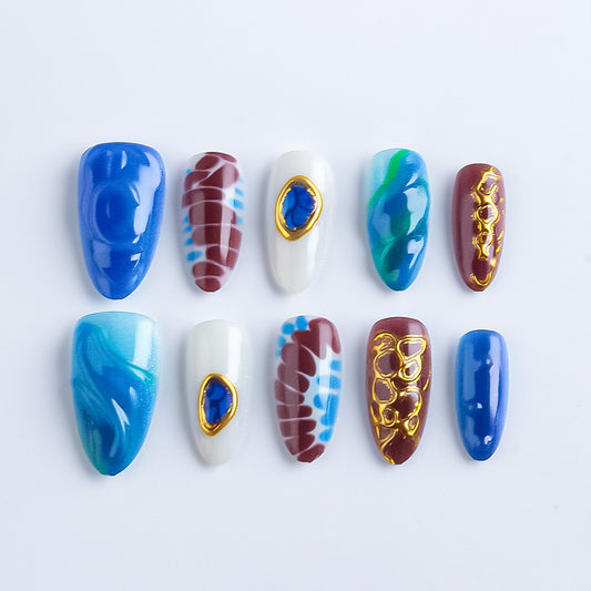 Oceanic Serenity Long Almond Blue and Brown Marble Nails with Gold Embellishments