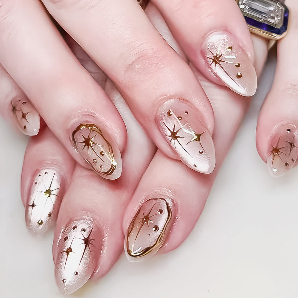 Celestial Elegance Medium Almond Pearl Beige with Shimmering Gold Star Accents Nail Set