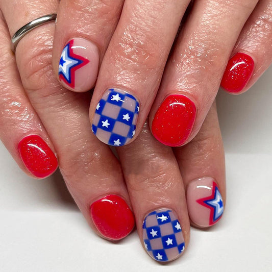 Patriotic Panache Short-Length Oval Press On Nails in Red, White, and Blue with Star and Lightning Bolt Accents