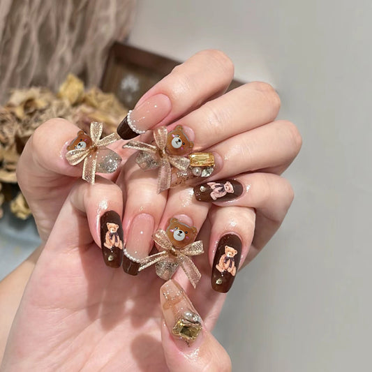 Charming Teddy Bear Themed Long Coffin Brown and Clear Press-On Nail Set with Sparkling Accents and Cute Bow Embellishments