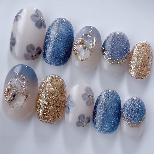 Set of nail designs with blue, gold, and white colors on a white background