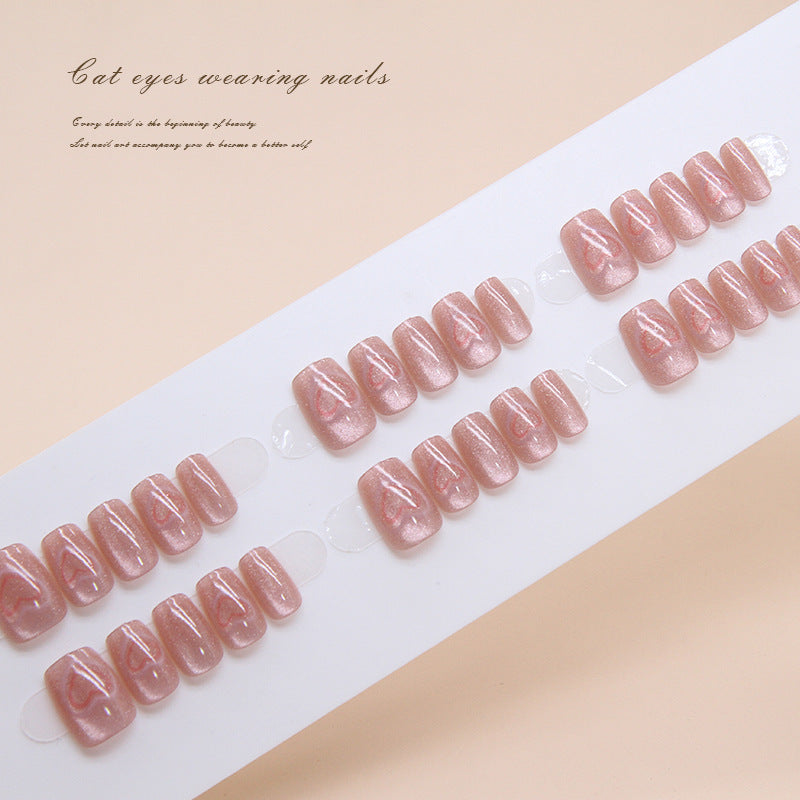 A set of pink glitter press-on nails presented in a fan-like arrangement, showcasing the short square shape and shimmer finish.