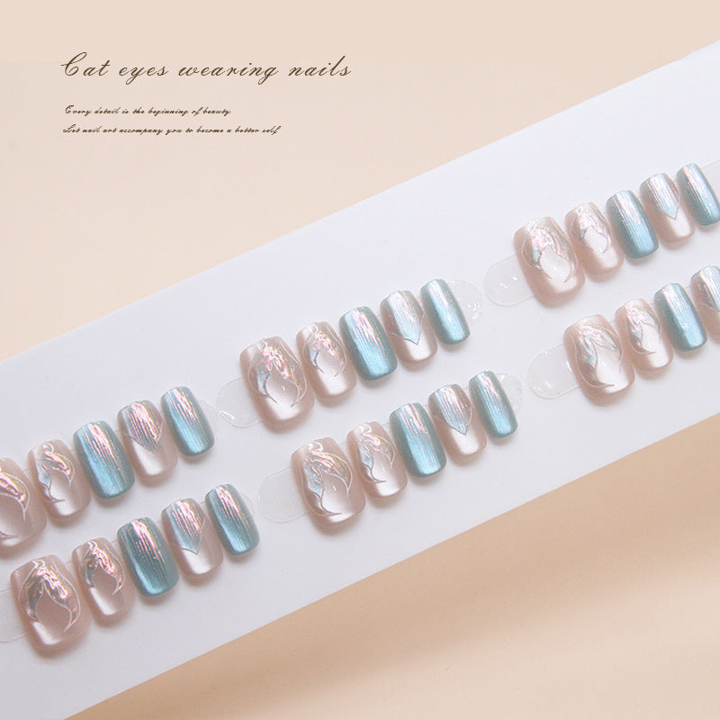 Set of press-on nails with a gradient design on a white tray.