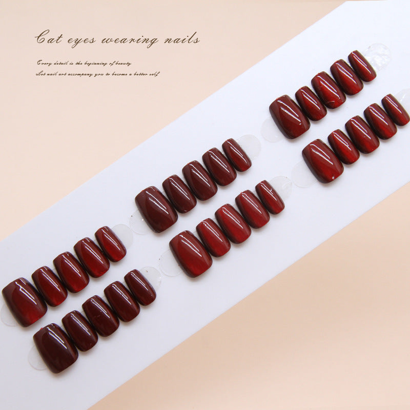 Set of red nail tips on a white tray with text on a beige background